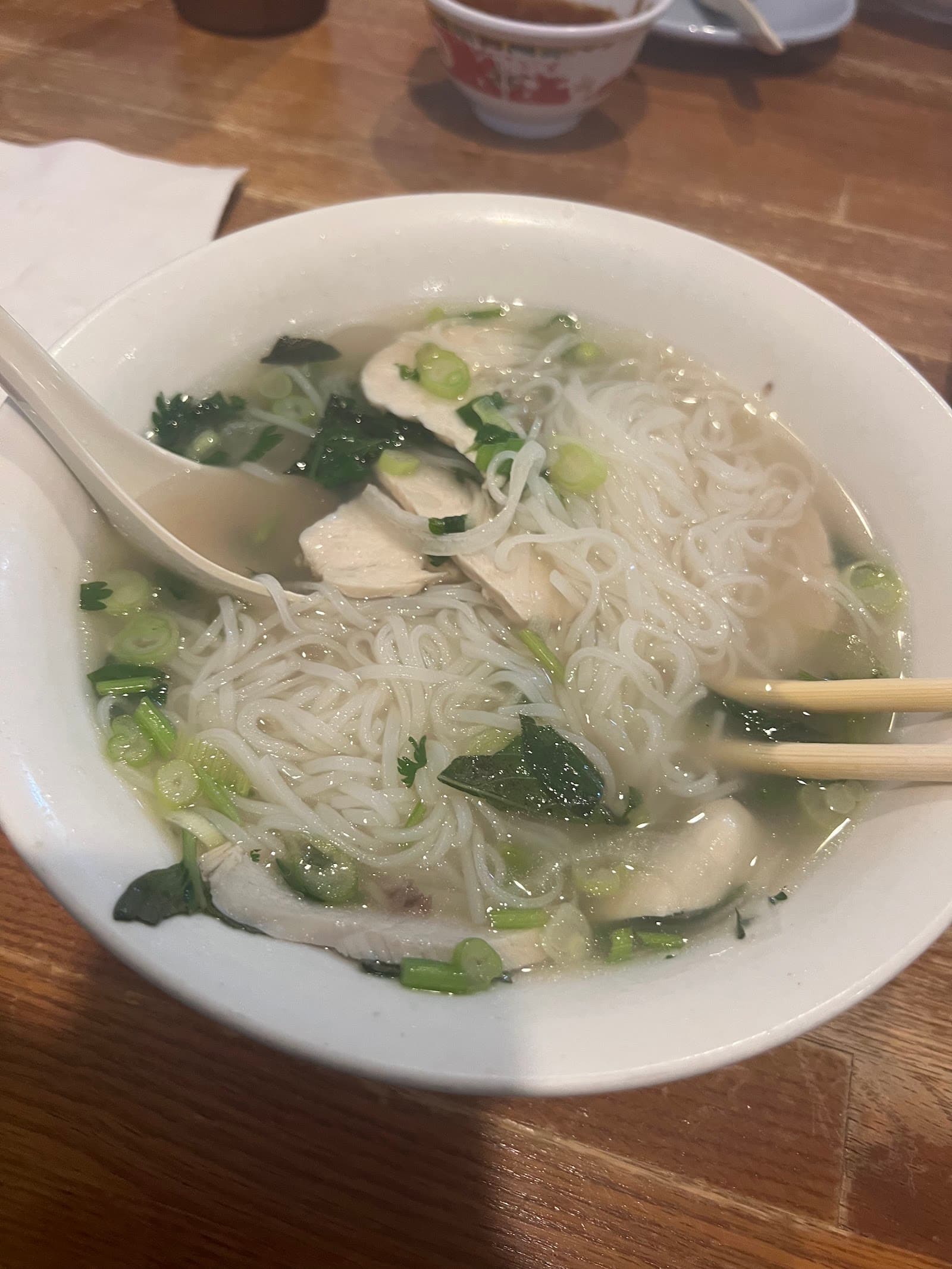 Warm interior dining room at Pho 24 — wooden tables, warm lighting, and a welcoming atmosphere