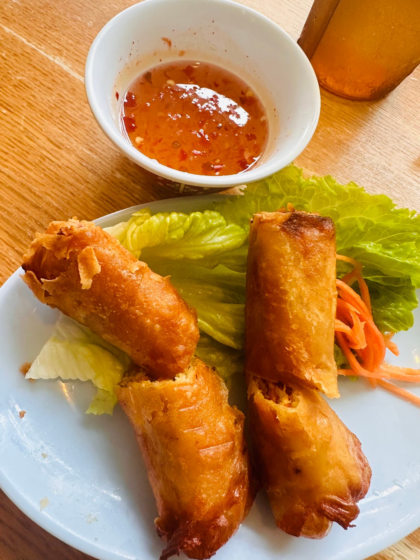 Steaming bowl of pho with fresh herbs, bean sprouts, and tender beef slices